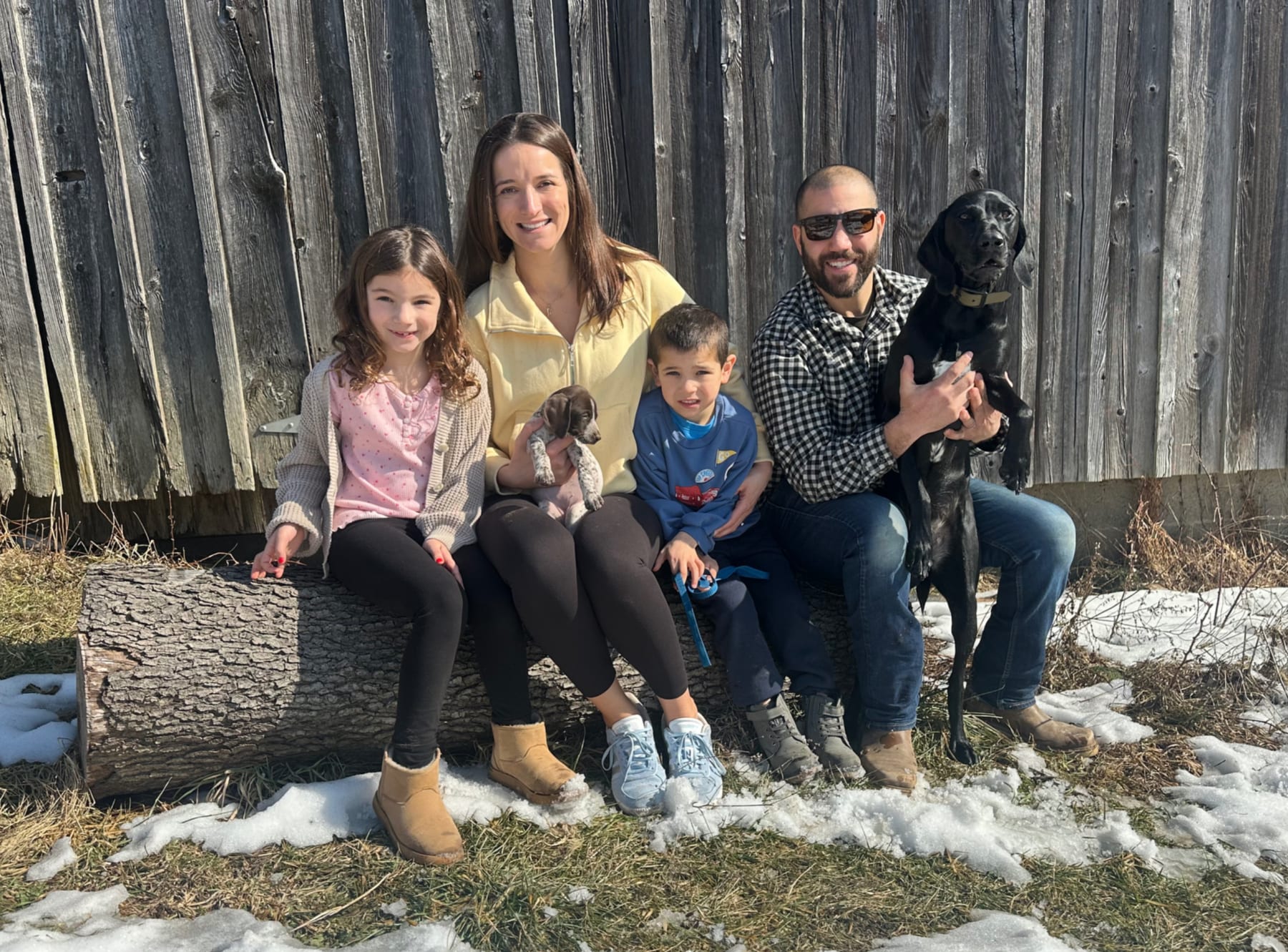 The family behind JR Signature Homes, outdoors with their dogs in Novelty, Ohio